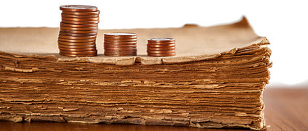 Copper coins on old book